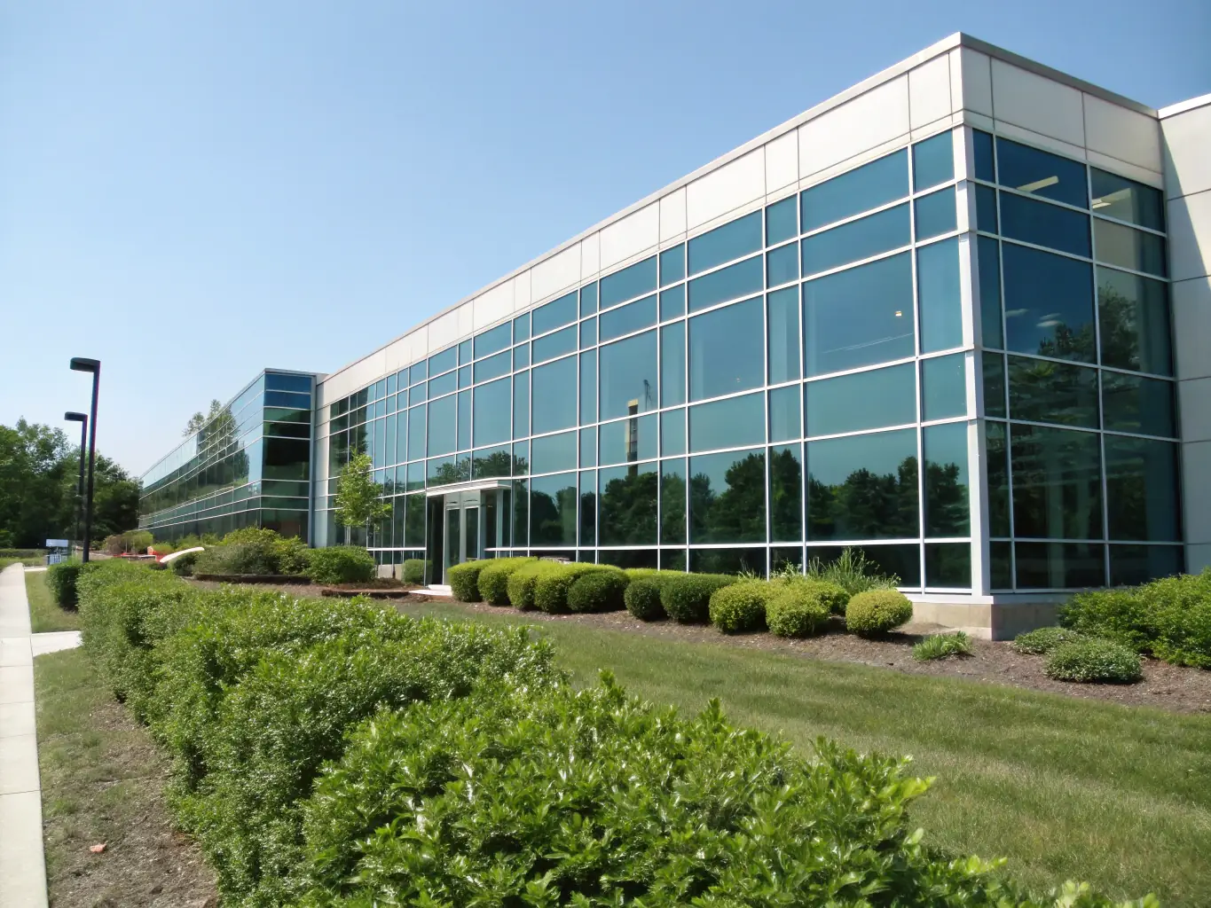 A well-maintained commercial building with a clear sky in the background, representing property protection and business continuity through insurance.